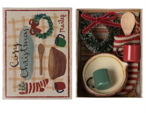 Decorative Christmas-themed matchbox set with tea cup, spoon, and other items.