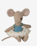 Stuffed mouse toy with a blue dress and polka dot cushion on a white background