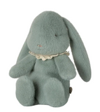 Green plush bunny with lace collar on a white background