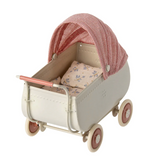 Doll's pram with a red checkered canopy on a white background