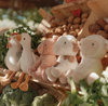 Plush toys of animals on a wooden stand with a blurred natural background