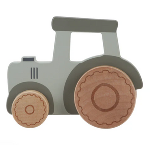 Toy tractor with wooden wheels on a white background