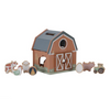 Wooden toy barn with farm animal figures on a white background