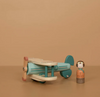 Wooden toy airplane and figure on a brown background