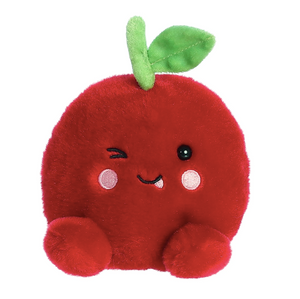 Plush toy shaped like a red apple with a smiling face on a white background