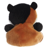 Plush toy of a black and orange creature on a white background