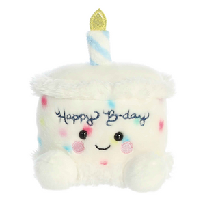 Plush toy shaped like a birthday cake with a candle and 'Happy B-day' text on a white background