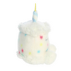 Plush toy resembling a birthday cake with a unicorn horn on a white background