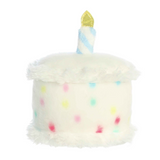 Plush toy shaped like a birthday cake with colorful candles on a white background
