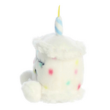 Plush toy resembling a unicorn with colorful sprinkles on a white background