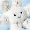 White plush toy with a smiling face against a light blue background
