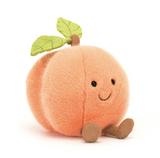 Plush toy shaped like a peach with a smiling face on a white background
