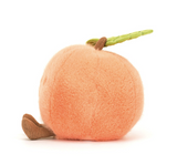 Plush toy resembling a peach on a white background