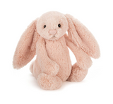 Plush toy rabbit in pink on a white background