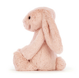 Pink plush bunny toy on a white background