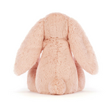 Pink plush bunny toy on a white background