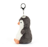 Plush penguin keychain with a clip on a white background