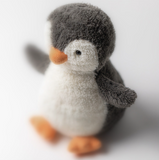 Stuffed penguin toy on a white background