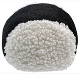 Round object with black top and white textured bottom