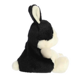 Black and white plush toy on a white background