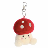Plush mushroom keychain with a red cap and white spots on a white background