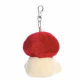 Red mushroom-shaped keychain with a white base on a white background