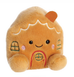 Plush toy shaped like a gingerbread house with a smiling face on a white background