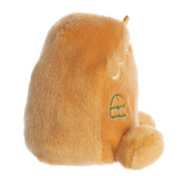 Plush toy resembling a cat with a green tag on a white background
