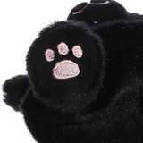 Black plush toy paw with pink paw print on a white background