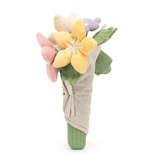 Toy bouquet with colorful flowers and green leaves on a white background