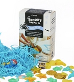 Sensory tray play kit with blue shredded paper, toy sea creatures, and a box labeled 'Sensory Tray Play Kit' on a white background.
