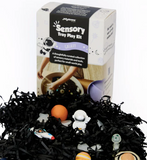 Sensory tray play kit with toys and packaging on a white background