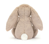 Plush bunny toy with beige fur and white feet on a white background