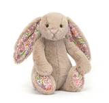 Floral-patterned plush bunny toy on a white background