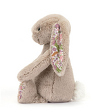 Floral embroidered bunny toy on a white background