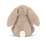 Plush bunny toy with beige fur on a white background