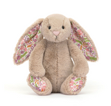 Plush bunny toy with floral ears and feet on a white background