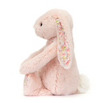 Pink plush bunny with floral ear on a white background