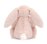 Pink plush bunny toy on a white background