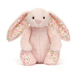 Floral-patterned pink plush bunny toy on a white background