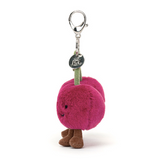 Plush keychain shaped like a pink plum with a tag on a white background