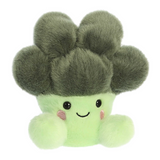 Plush toy shaped like a cactus with a smiling face on a white background