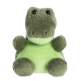 Green plush toy with a white belly on a white background