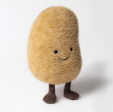 Stuffed toy resembling a brown potato with a smiling face on a white background