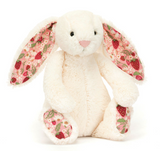 Plush bunny toy with strawberry pattern on a white background