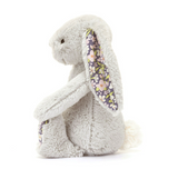 Plush bunny toy with floral ear on a white background