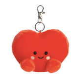 Red heart-shaped plush keychain with a smiling face on a white background