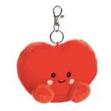 Red plush heart-shaped keychain with a smiling face on a white background