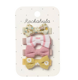 Set of three colorful bow hair clips on a Rockahula branded card.