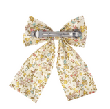 Floral-patterned bow hair clip on a white background